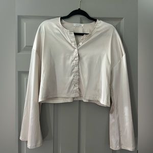 Silk like, bell shaped, long sleeved shirt